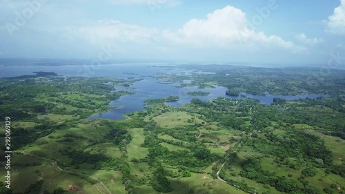 aerial view of green filds, trees, gatun lake on sunny day photo