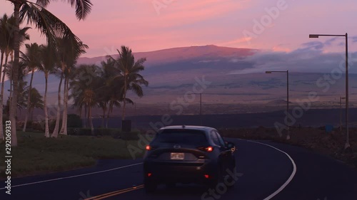 Sunset Mauna Lani Roadway to Mauna Kea Volcano Sunset with Telescopes and Mazda car on Road Hawaii photo