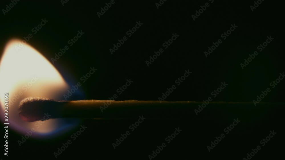 Burning match on a black background. Macro extreme close up shot of a wooden match igniting after being heated up, and bursting into flames burning till the end. Recorded in Raw on Blackmagic camera. Burning match on a black background. Macro extreme close up shot of a wooden match igniting after being heated up, and bursting into flames burning till the end. Recorded in Raw on Blackmagic camera.
