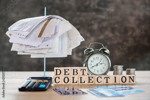 debt collection concept with unpaid bills,calculator,coin on desk 