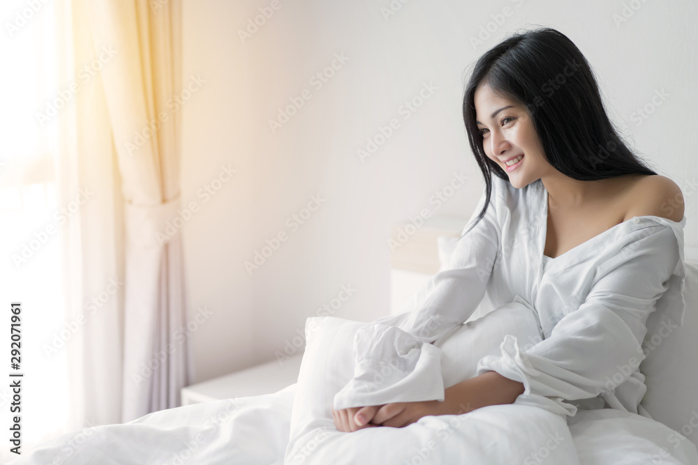 Beautiful young woman wake up and stretch oneself in the morning at bedroom Beautiful young woman wake up and stretch oneself in the morning at bedroom