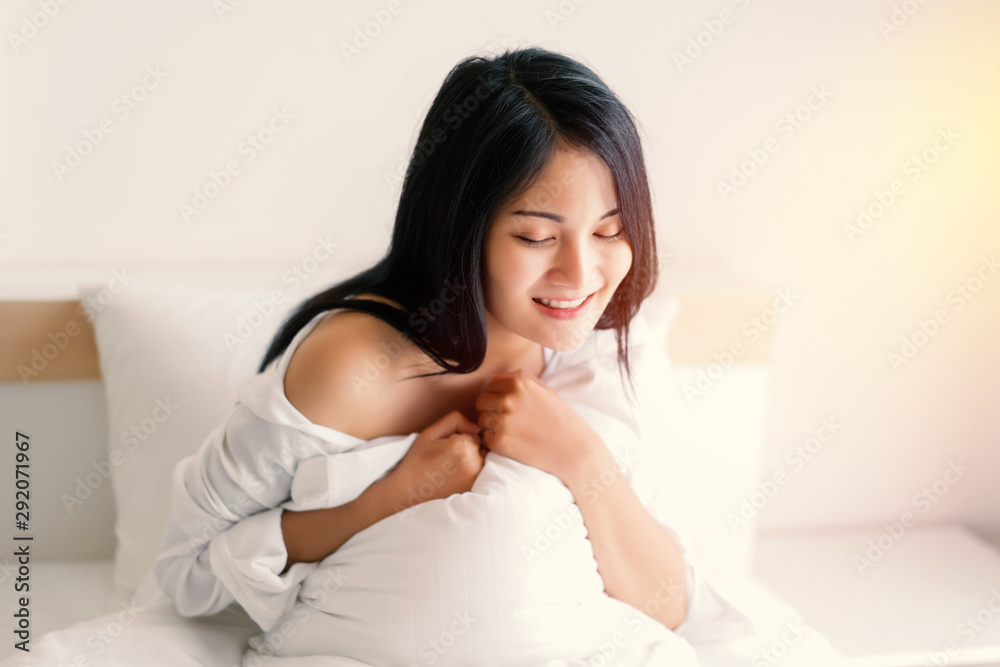 Beautiful young woman wake up and stretch oneself in the morning at bedroom Beautiful young woman wake up and stretch oneself in the morning at bedroom