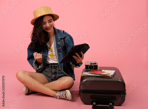woman backpacker traveler holding tablet. journey trip travel. studio shot