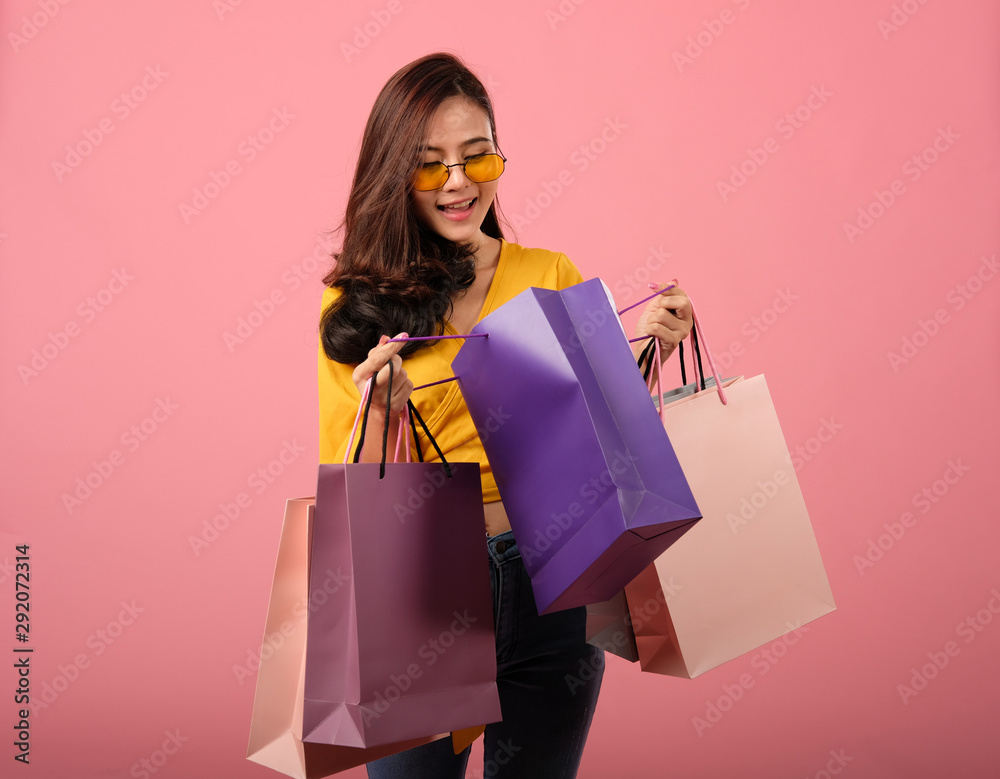 woman holding shopping bags. consumerism lifestyle studio shot