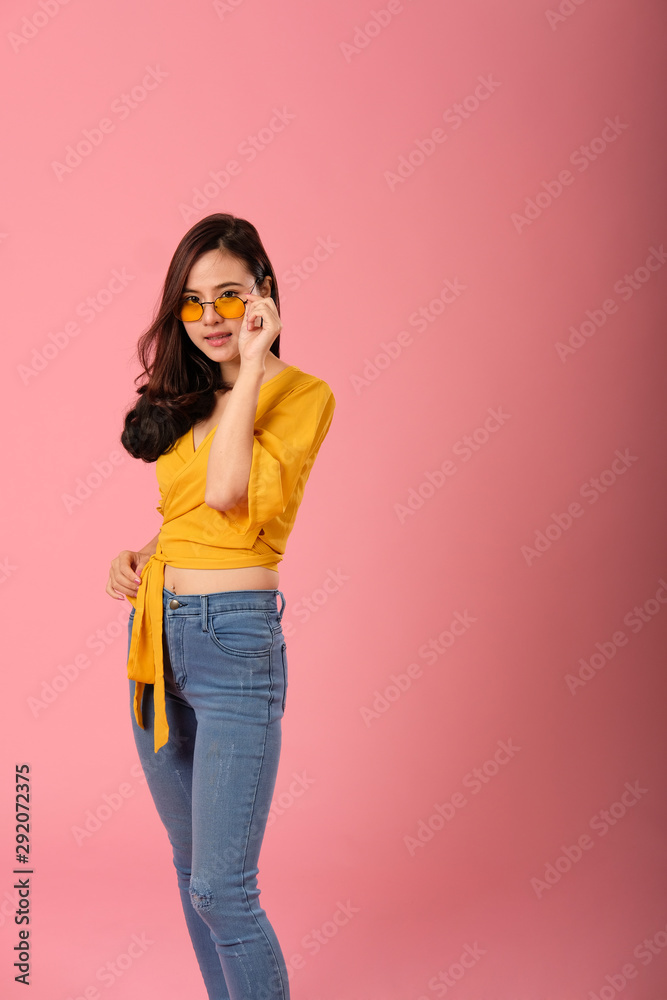 portrait of smiling asian woman in casual clothing. studio shot