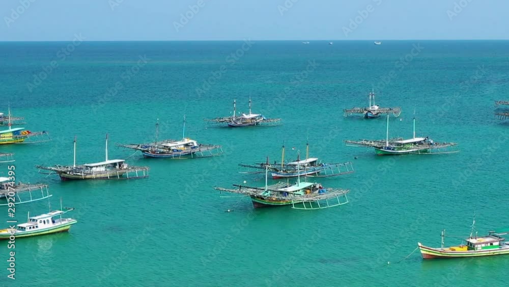 Aerial Drone Video flying above Fishing Village of Tanjung Binga in Belitung Island Indonesia. Fishing Boat on Clear water, village houses Aerial Drone Video flying above Fishing Village of Tanjung Binga in Belitung Island Indonesia. Fishing Boat on Clear water, village houses