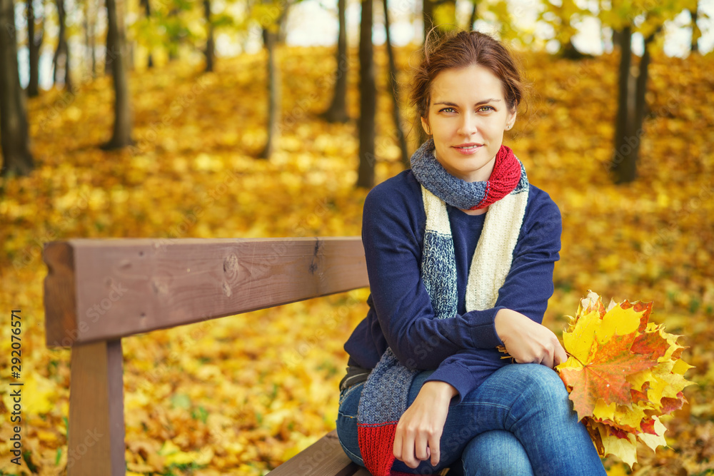 Young beautiful woman in autumn park