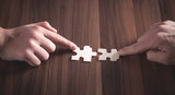 Hands holding jigsaw puzzle piece. Solution, Success, Teamwork