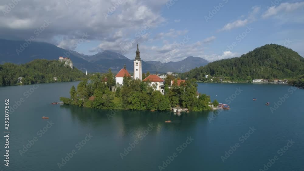 Spinning aerial during the day at Lake Bled Slovenia with tourists going to the Bled Island Spinning aerial during the day at Lake Bled Slovenia with tourists going to the Bled Island