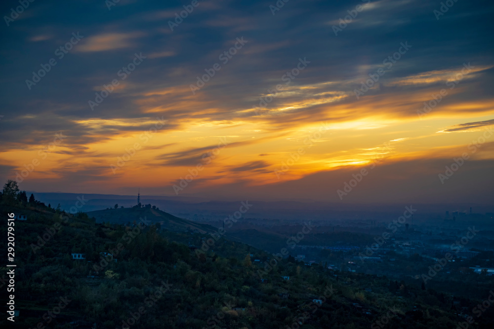 Sunset over the city, view from the hill