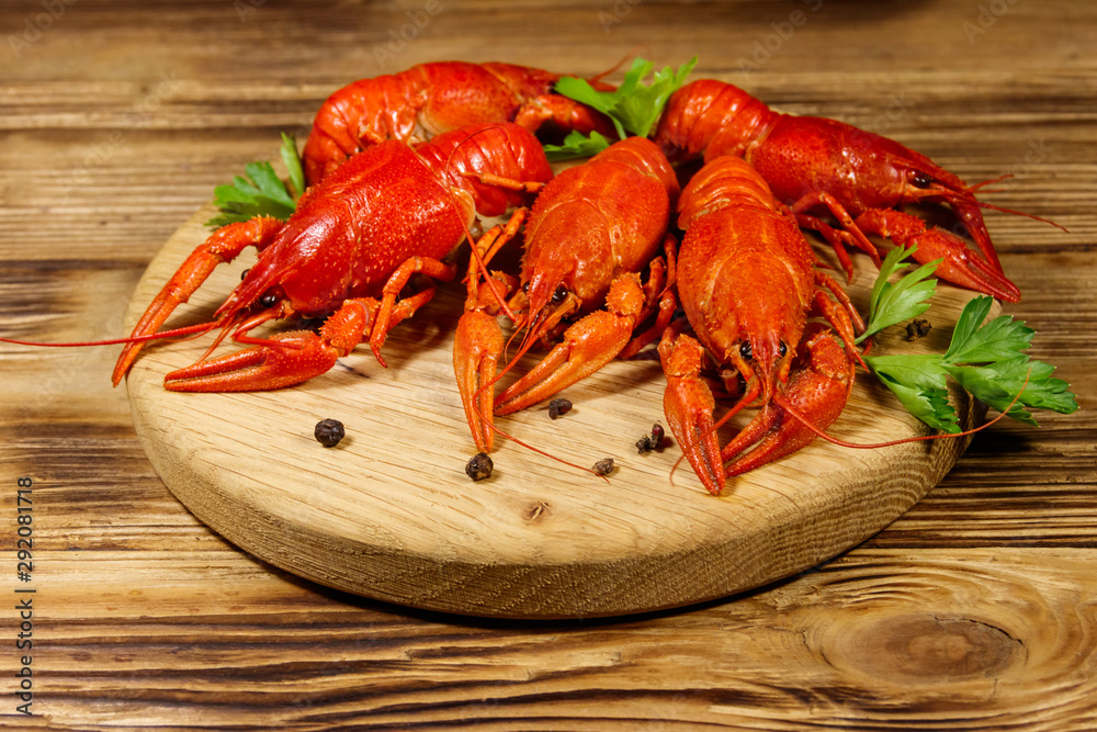 Boiled crayfish on cutting board on wooden table Boiled crayfish on cutting board on wooden table
