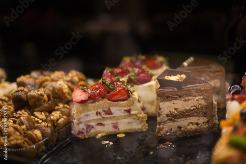 delicious street food and deserts in Istanbul city, Turkey. Chocolate cakes and strawberry shortcake pies. Fresh Fruit Tart with berries in display at a street food market