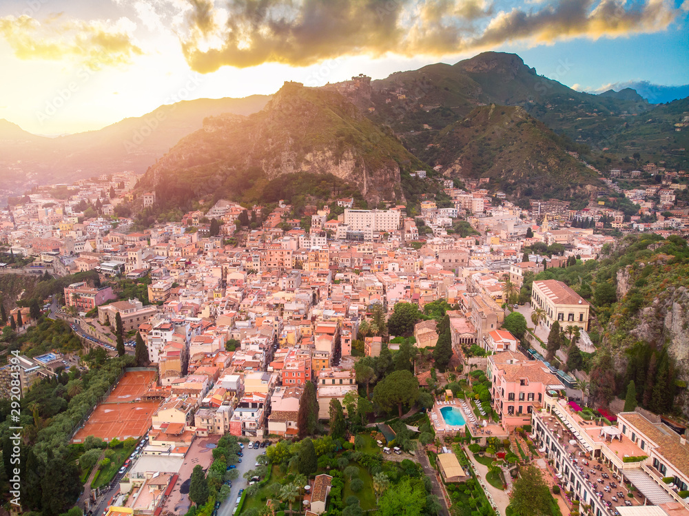 Taormina, Sicily Italy sunset, volcano Etna in clouds. Aerial top view, drone photo