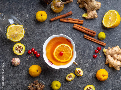 Cup of ginger hot tea with lemon and honey, cinnamon. autumn or winter drink