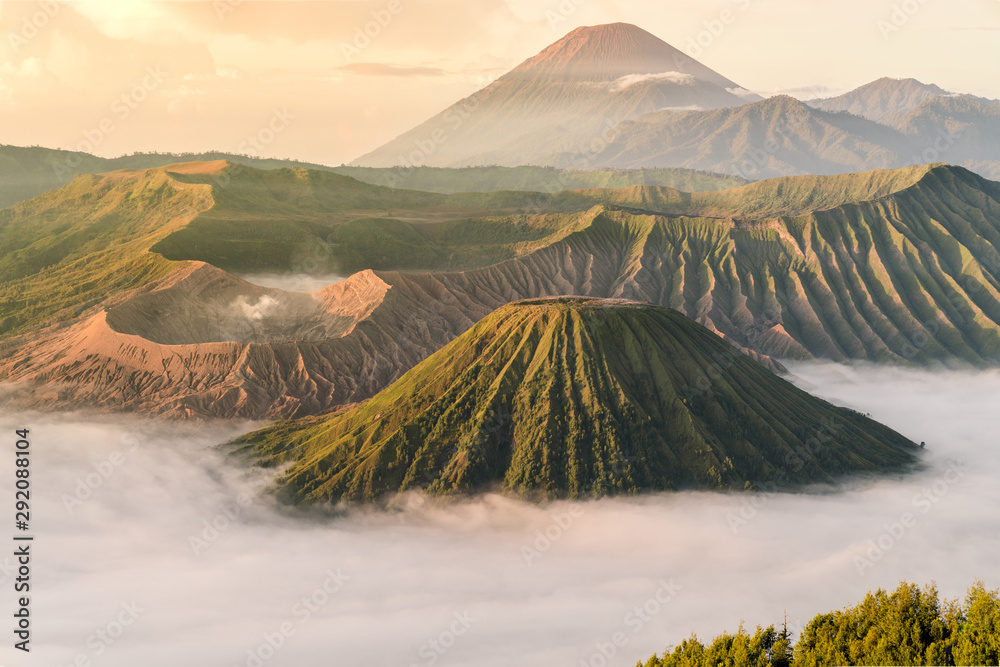 Beautiful view of Mount Bromo volcano during sunrise with white mist at Bromo tengger semeru national park, East Java, Indonesia - obrazy, fototapety, plakaty 