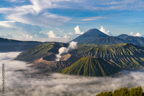 Beautiful view of Mount Bromo volcano during sunrise with white mist at Bromo tengger semeru national park, East Java, Indonesia photo