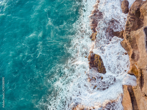 Aerial view of sea waves and fantastic rock cliff. Beautiful ocean waves. Top view from drone.
