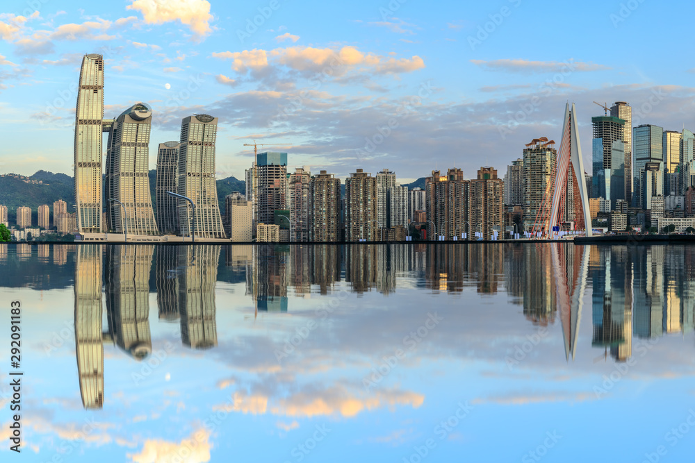 Chongqing skyline and modern urban skyscrapers with water reflection at sunset,China.