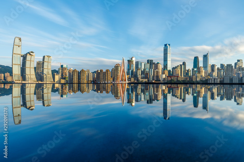 Chongqing skyline and modern urban skyscrapers with water reflection at sunset,China. © ABCDstock