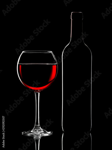 Silhouette of red wine bottle and glass