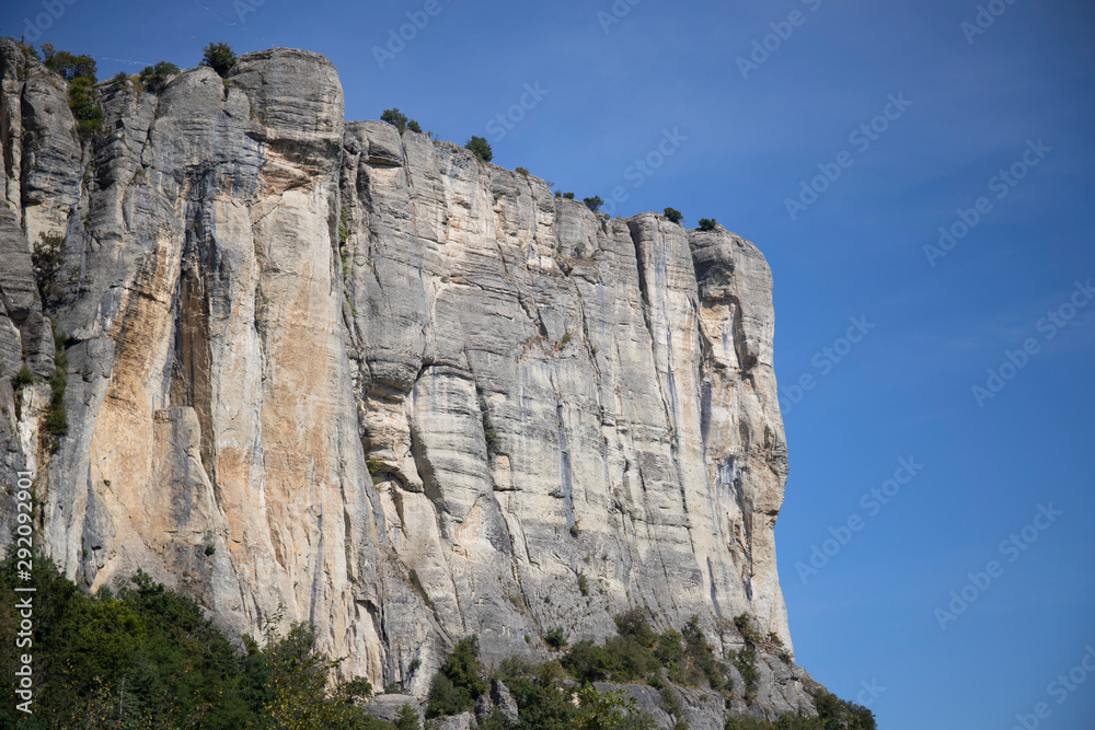 The vertical cliffs of the stone of Bismantova with blue sky in the background. Emilia Romagna, Italy.