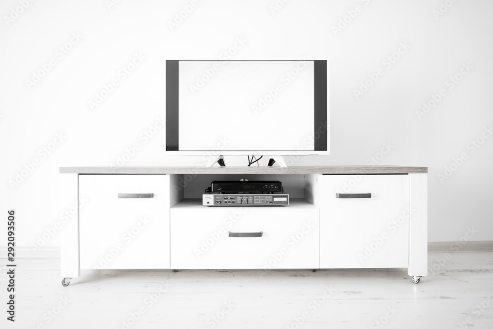 TV with white screen on a stand in the room. TV with white screen on a stand in the room.
