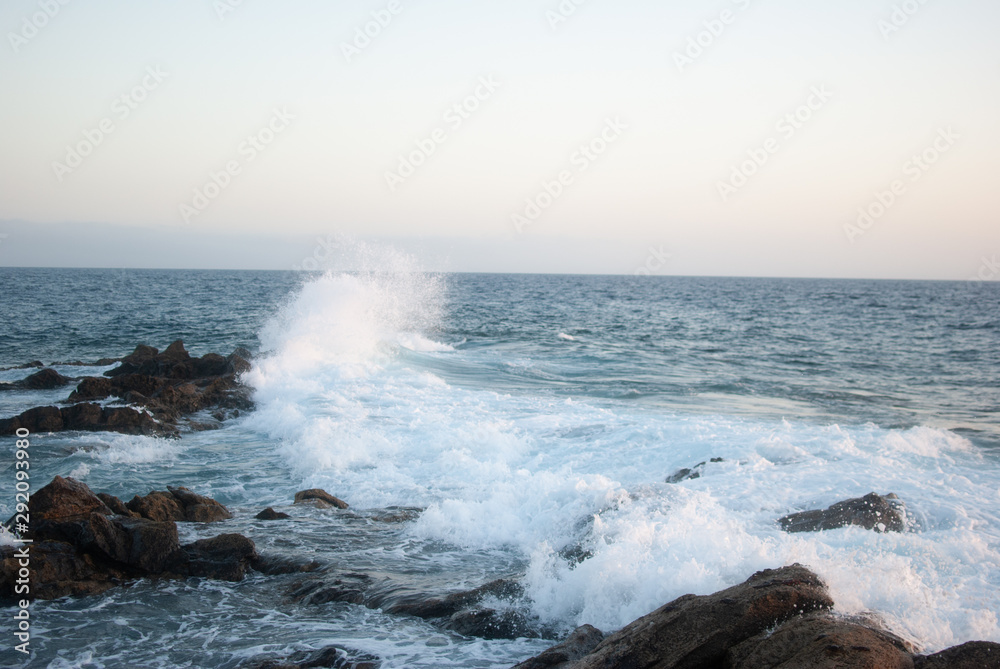ocean waves crash on stones canary islands