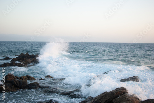 ocean waves crash on stones canary islands