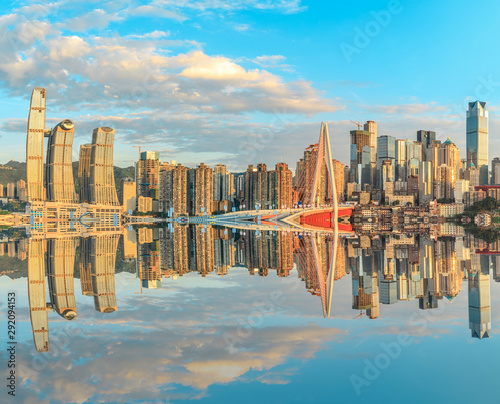 Chongqing skyline and modern urban skyscrapers with water reflection at sunset,China. © ABCDstock