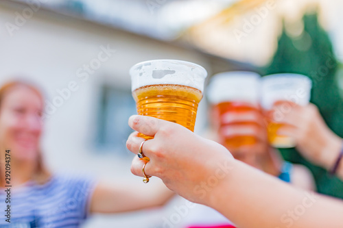 Friends enjoying drinking beer in the backyard.