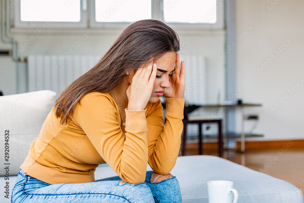 Sinus ache causing very paintful headache. Unhealthy woman in pain. Sharp strong sore. Sinus pain, sinus pressure, sinusitis. Sad woman holding her head because sinus pain