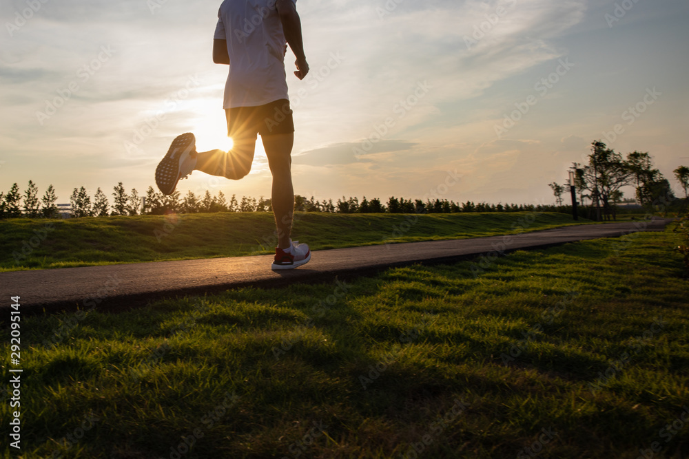 healthy lifestyle young woman runner running on sunrise seaside road 