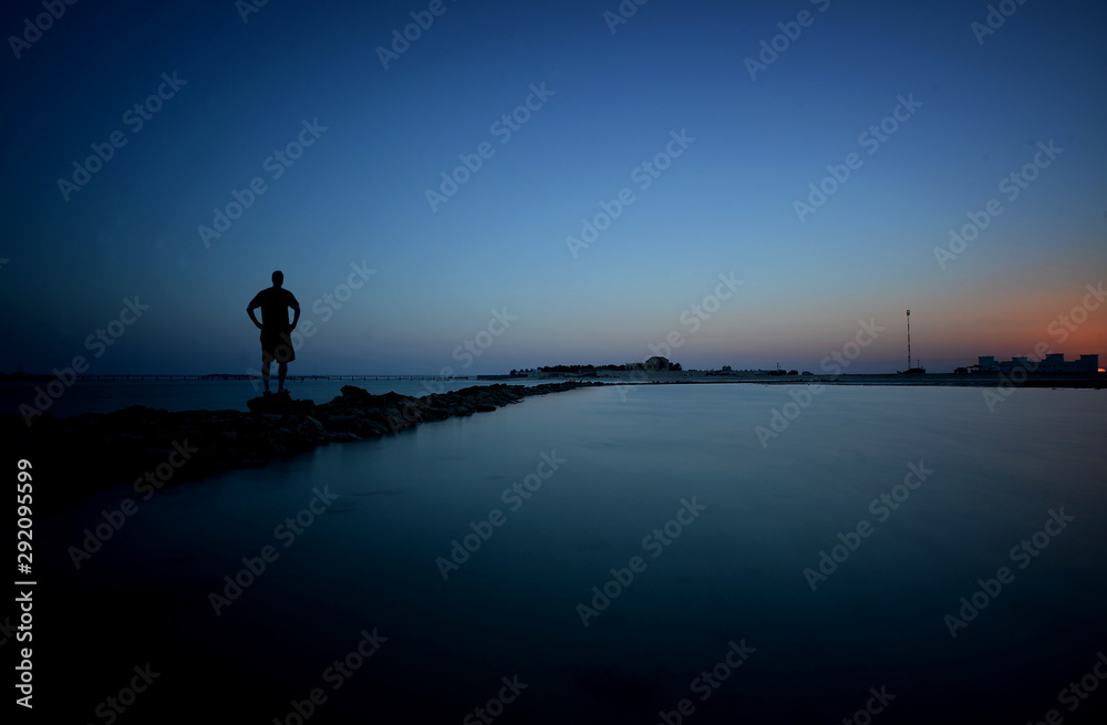 A man enjoying an evening at the sea shore.