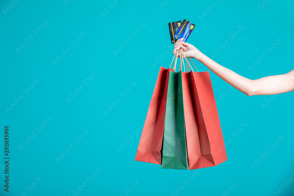 woman holding shopping bag and credit card