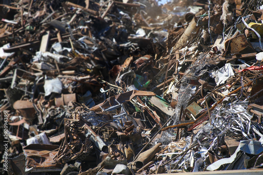 Scrap yard, close-up. Foreground sharp, background blurred. Background of rusty scrap metal. Scrap yard, close-up. Foreground sharp, background blurred. Background of rusty scrap metal.