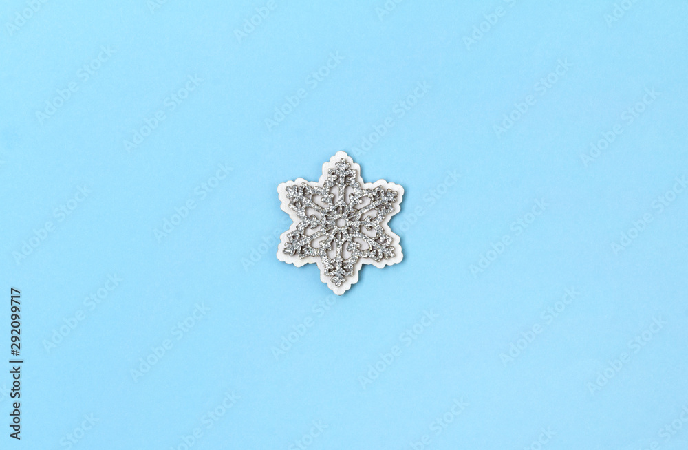 Wooden glittering snowflakes on blue pastel background. Wooden glittering snowflakes on blue pastel background.