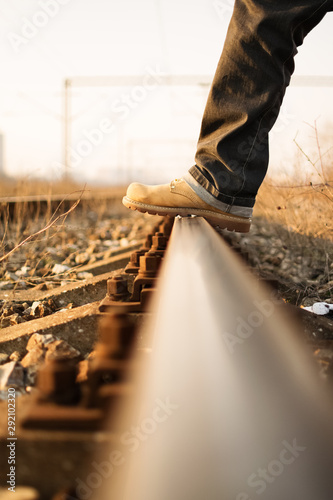 Stepping over the train tracks photo