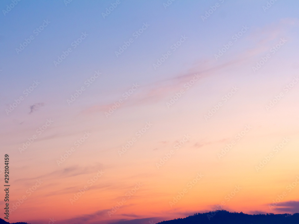clear orange yellow sky background with blue clouds sunset or sunrise morning abstract texture. clear orange yellow sky background with blue clouds sunset or sunrise morning abstract texture.