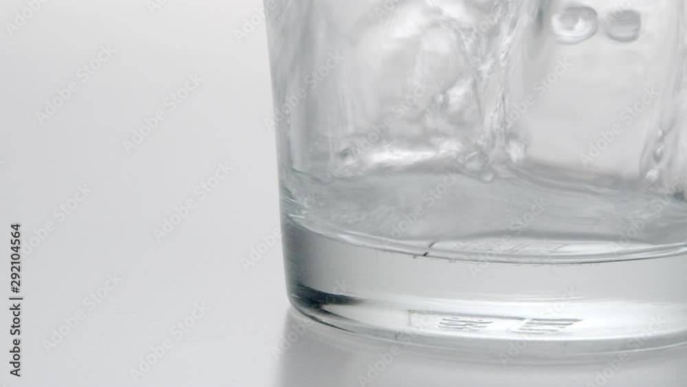 Slowmotion fresh mineral water pouring in to a glass .healty food and drink concept.cold beverage refreshing . Slowmotion fresh mineral water pouring in to a glass .healty food and drink concept.cold beverage refreshing .