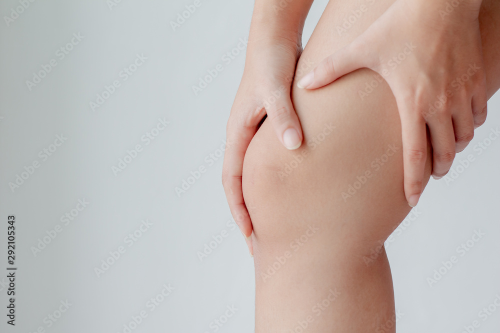 Closeup young  Woman suffering from pain in knee. Healthcare and medical concept.