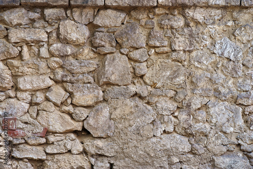 Ancient wall made of natural stones, old masonry as background