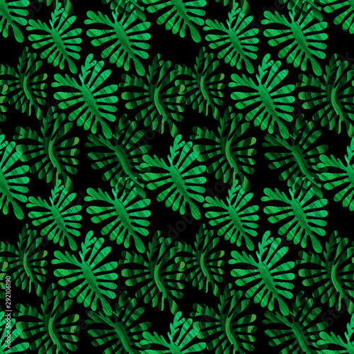 Abstract tropical leaves with green colors texture drawn on a dark background