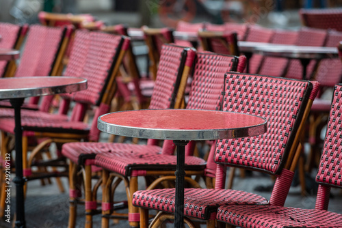 Parisian café terrace with red rattan furniture a rainy day