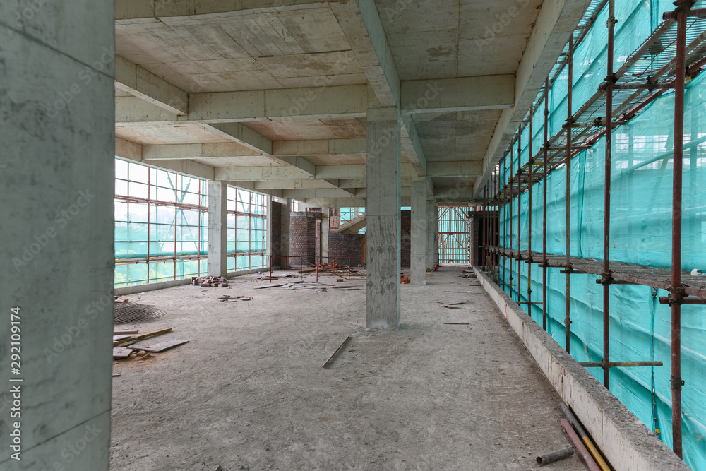inside of an unfinished building with protection scaffolding and netting surrounded