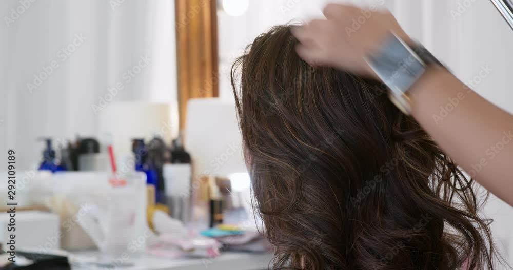 Hairdresser creating a hairstyle for bride in salon Hairdresser creating a hairstyle for bride in salon