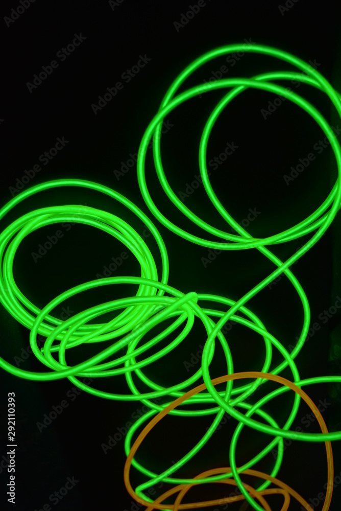 Bright luminous yellow and green, lime neon wires in different formats and layouts. An electroluminescent wire, a neon light guide, an ice tube are folded into different structures and shapes. Bright luminous yellow and green, lime neon wires in different formats and layouts. An electroluminescent wire, a neon light guide, an ice tube are folded into different structures and shapes.