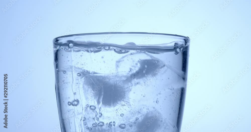 Slowmotion fresh mineral water pouring in to a glass .healty food and drink concept.cold beverage refreshing .
