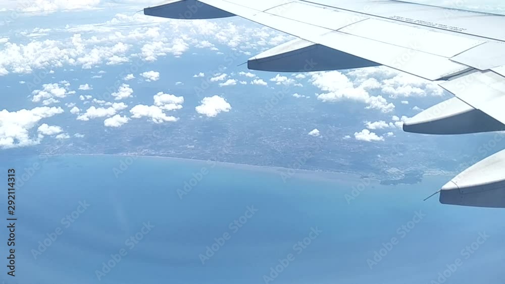 wing of an airplane flying above clouds wing of an airplane flying above clouds