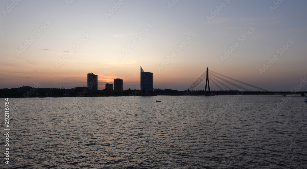 Beautiful view of cable-stayed bridge across the Daugava river in Riga forward on sunset panoramic front view