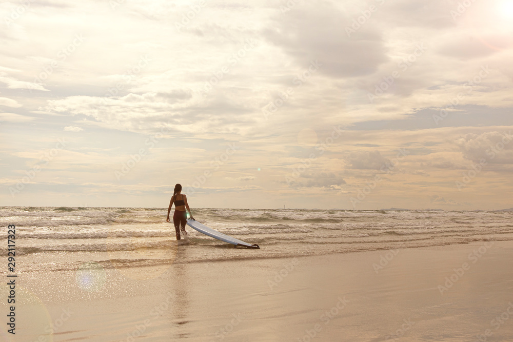 Woman surfer on the beach